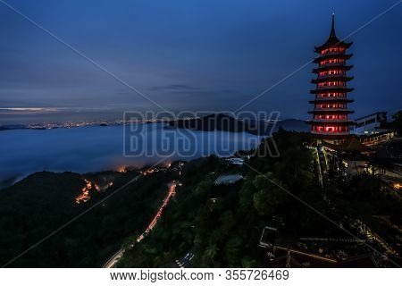 Chin Swee Caves Temple Pagoda In Night View With Fog Cover Over The Distance