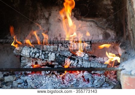 Burning Firewood In The Fireplace Close Up, Bbq Fire. Charcoal Fire With Sparks.
