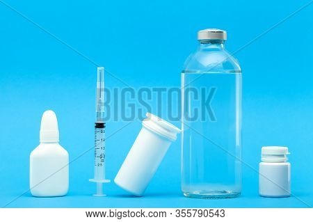 Medicines For The Treatment Of Diseases In Plastic Bottles And A Vaccine In A Glass Bottle With An I