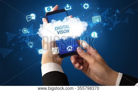 Female hand holding smartphone with DIGITAL VISON inscription, cloud technology concept