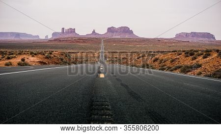 Empty Road To Monument Valley In The Middle Of Desert
