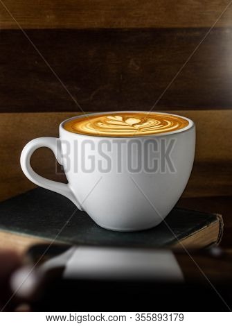 White Cup Of Latte Art Capuccino With Reflection