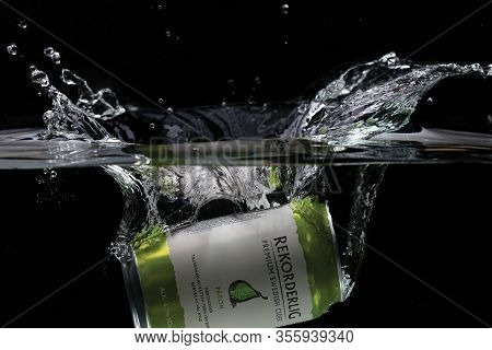 Close Up View Of Can Falling In Water. Pear Sider. Sweden. Uppsala. 03.14.2020.