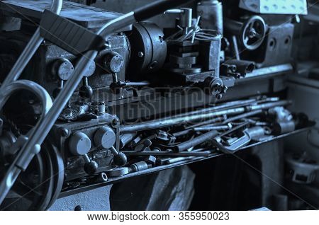 Outdated Lathe In An Old Workshop. Outdated Metalworking Machine In An Abandoned Home Workshop. Meta