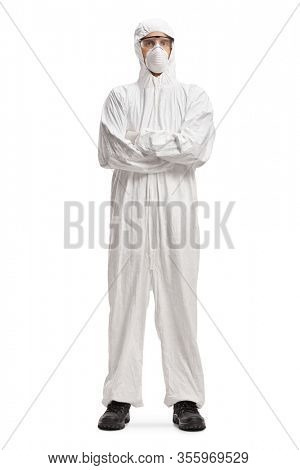 Full length portrait of a man wearing a decontamination suit and mask and posing with crossed arms isolated on white background