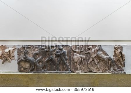 Delphi, Greece - September 21, 2017: Ancient Greek Parts Of Marble Plaque With Battle Scene In Museu