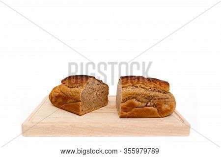 A Homemade Plumcake Standing On A Wooden Board With A White Background