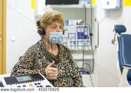 Audiologist Checks The Hearing Of An Older Woman