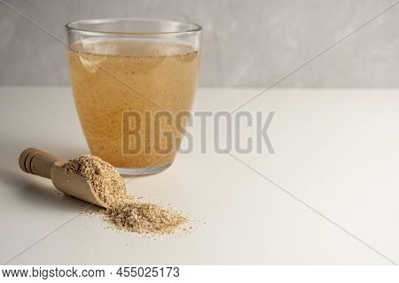 Psyllium In A Glass On A White Background With Psyllium Husk.