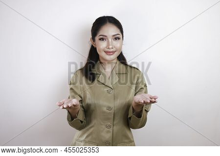 A Young Beautiful Asian Worker With A Brown Uniform Is Presenting. Indonesian Pns.