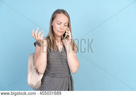 Middle Caucasian In Casual Clothes With Backpack And Mobile Phone Talking And Gesturing, Isolated On