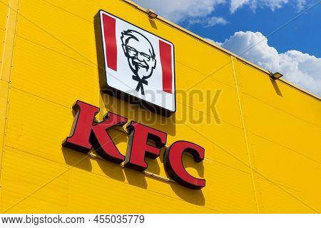 Krasnoyarsk, Russia - May 19, 2022: Red Kfc Restaurant Logo On Yellow Facade Building. Kfc Is A Fast