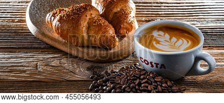 Cup Of Costa Coffee On A Wooden Table