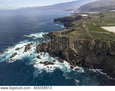 Aerial View On Charco Del Viento Natural Pool In Black Lava Rocks And Banana Tree Plantation On Tene