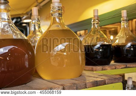 Big Bottles With White And Red Wine Austrian Vinegar Made From Local Grapes On Market In Vienna, Aus