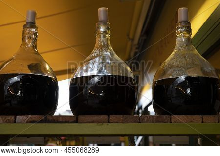 Big Bottles With White And Red Wine Austrian Vinegar Made From Local Grapes On Market In Vienna, Aus
