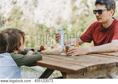 Close-up View Of Father And His School Boy Son On A Family Picnic In The Mountains. Child Kid And Hi