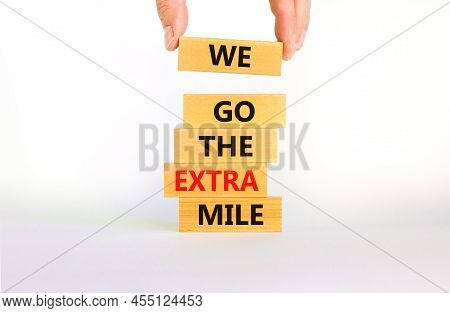 We Go The Extra Mile Symbol. Wooden Blocks With Words We Go The Extra Mile. Beautiful White Backgrou