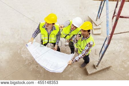 Top View Female Lead Architect Consulted With Two Male Workers Standing Near The Scaffolding And Poi