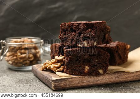 Delicious Chocolate Brownies With Nuts On Grey Table