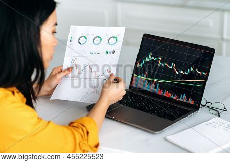 Successful Smart Woman Crypto Trader, An Investor, Uses Laptop, Analyzes The Charts Of Trading In Th