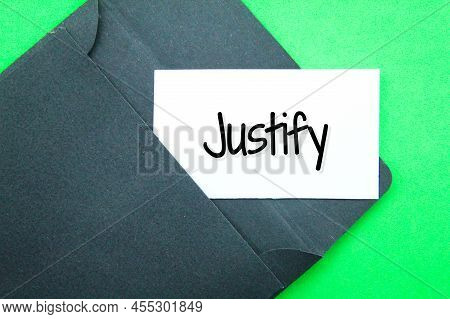 Black Envelope And White Paper With The Word Justify