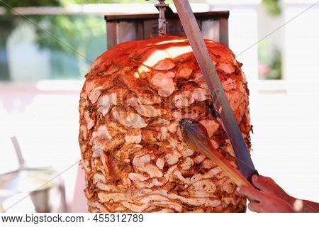 Chef Cuts Grilled Chicken Meat From Rotating Spit And Prepares Traditional Street Food. Street Shawa