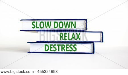 Destress Symbol. Concept Words Slow Down Relax Destress On Books. Beautiful White Table White Backgr