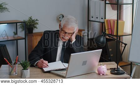 Senior Mature Older Business Man Accountant, Analysing Paperwork Documents Loses Becoming Surprised 