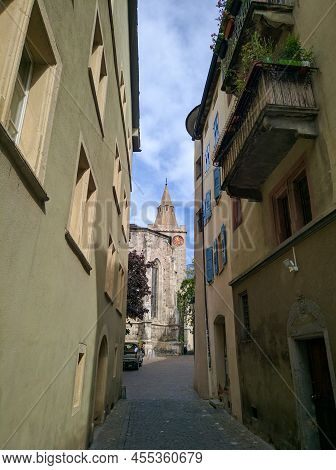 Sion, Switzerland - August 22, 2019: Narrow Street Of The Old City Sion. View Of The Chapel Of Our L