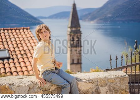 Boy Tourist Enjoying Colorful Street In Old Town Of Perast On A Sunny Day, Montenegro. Travel To Mon