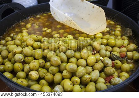 Crushed Marinated Olives. Delicious Pickled Snack Displayed Plastic Basket