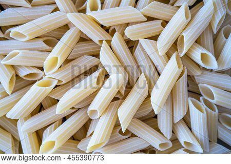 Close Up Photo Of Raw Penne Pasta.