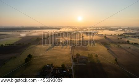 Aerial Drone Shot Of A Beautiful Green And Yellow Agricultural Plantations Bordering With Wild Fores