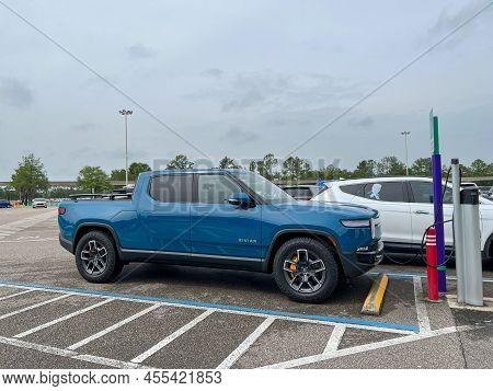 A Rivian Ev Truck Parked In A Parking Lot In Orlando, Florida.