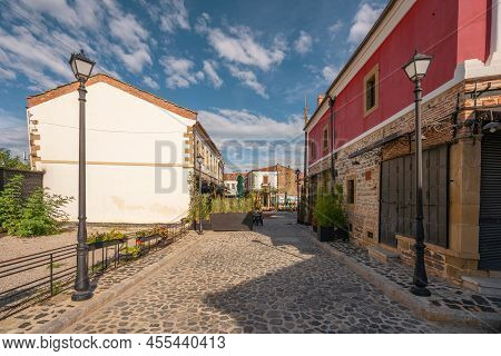One Of The Sights Of Korca, Albania, Ottoman Old Bazaar With Blue Cloudy Sky.