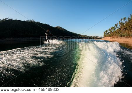 Magnificent View Of Man Riding On Foil Wakeboard At Splashing Wave
