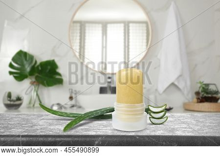 Natural Crystal Alum Deodorant And Aloe On Grey Table In Bathroom