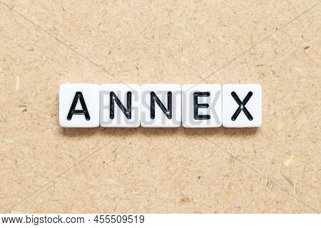 White Tile Alphabet Letter With Word Annex On Wood Background