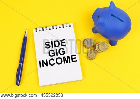 Business And Finance Concept. On A Yellow Surface, A Piggy Bank, Coins And A Notepad With The Inscri
