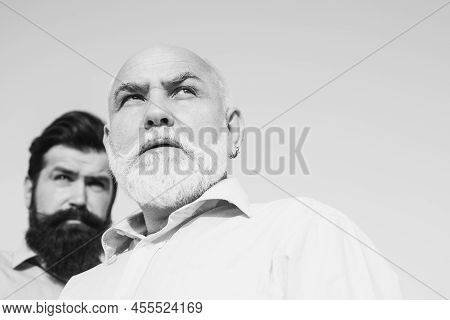 Two Different Generations Ages: Grandfather And Father Together. Grandfather With Son In Park. Grand