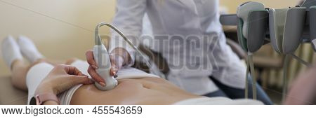 Close-up Of Gynecologist Doing Ultrasound Scan In Modern Clinic, Doctor In White Lab Coat Examining 