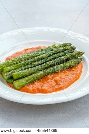 Fried Asparagus With Romesco Sauce On White Plate