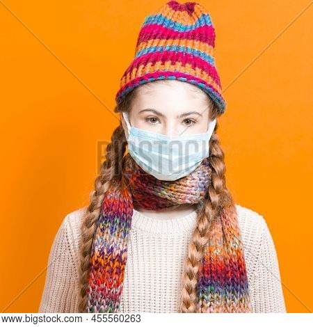 Healthcare Ideas.teenage Female Girl In Warm Knitted Hat And Scarf Using Facial Mask Against Viruses