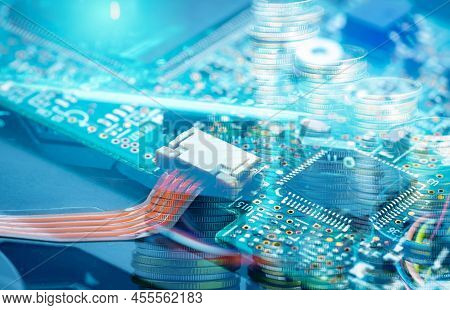 Electronic Circuit Board And Coin Stack. Mainboard Of Computer. Electronic Business Industry.  Compu