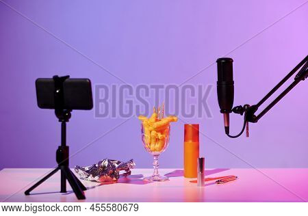 No People Still Life Shot Of Microphone, Smartphone On Tripod, Glass With Crunchy Snacks, Foil And C