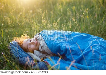 A Child Sleeps In A Sleeping Bag On The Grass In A Camping Trip - Eco-friendly Outdoor Recreation, H