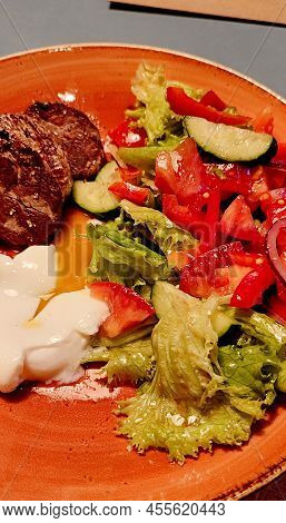 Restaurant Food Grilled Pork Chop With Warm Bell Pepper Salad Close-up In A Plate.