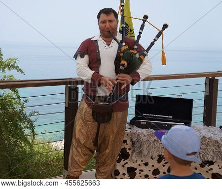 Herzliya, Israel - March 28, 2022: Historical Reconstructor Musician Plays Bagpipes For Public