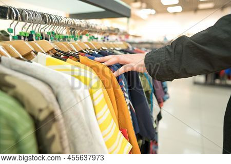 Man Looking For Clothing At Marketshop. Man At Shopping - New Fashion Collection At Fashionable Clot